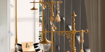 a room with a tall lamp post and tables