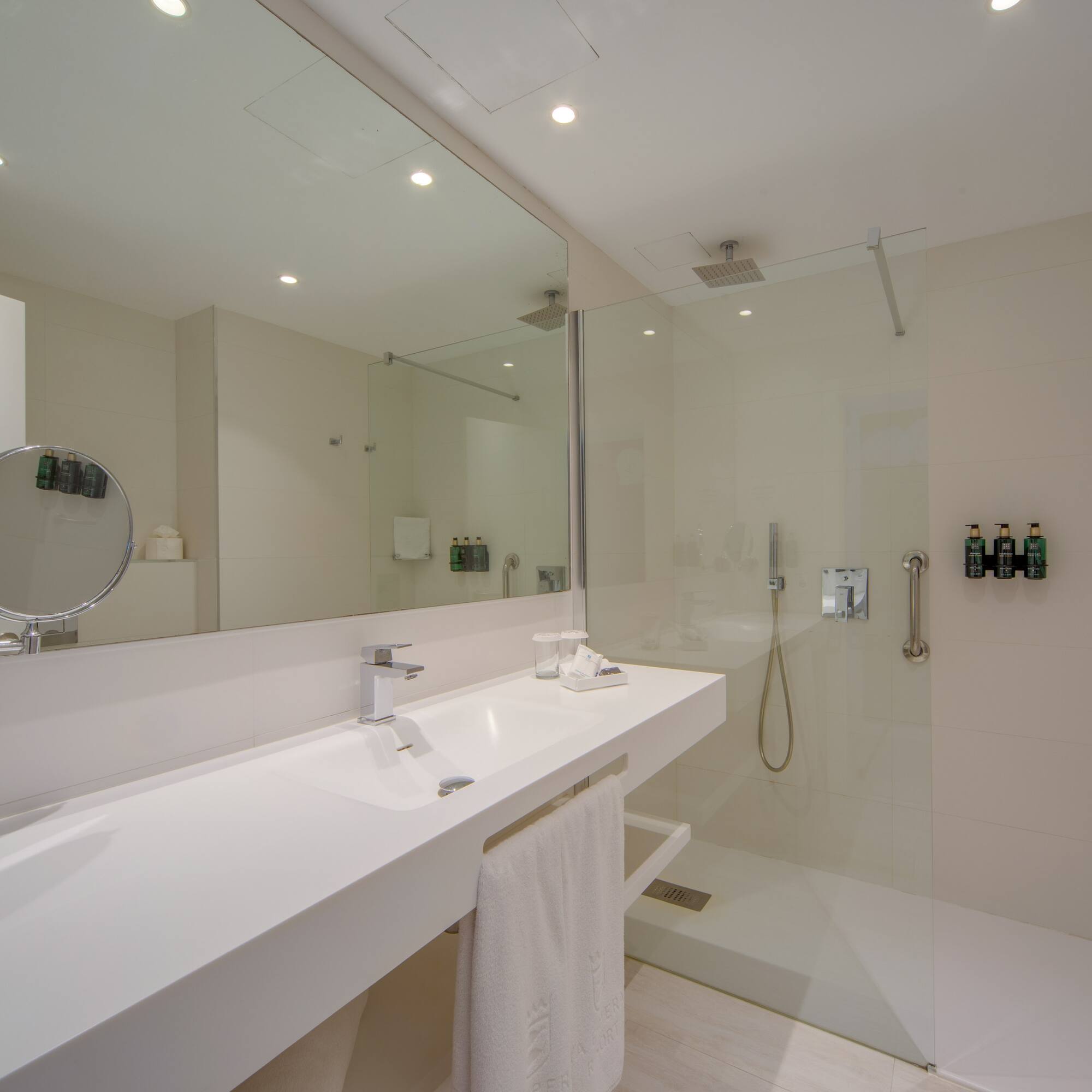 a bathroom with a glass shower and sink