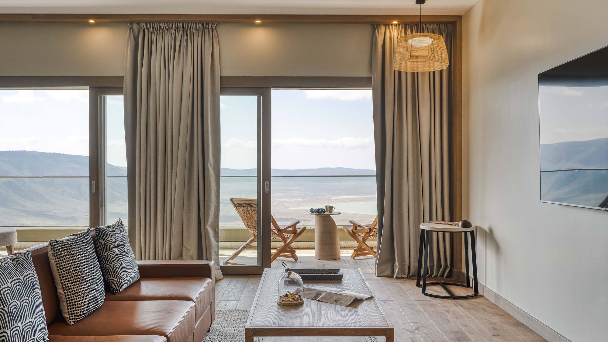 a living room with a view of the ocean and a couch