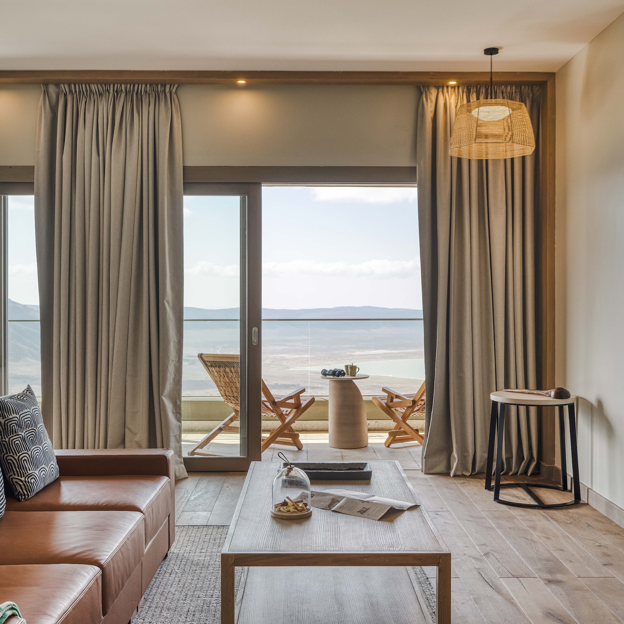 a living room with a view of the ocean and a couch