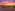 Vibrant sunset over resort hotel rooftop bar, ocean, and beach.
