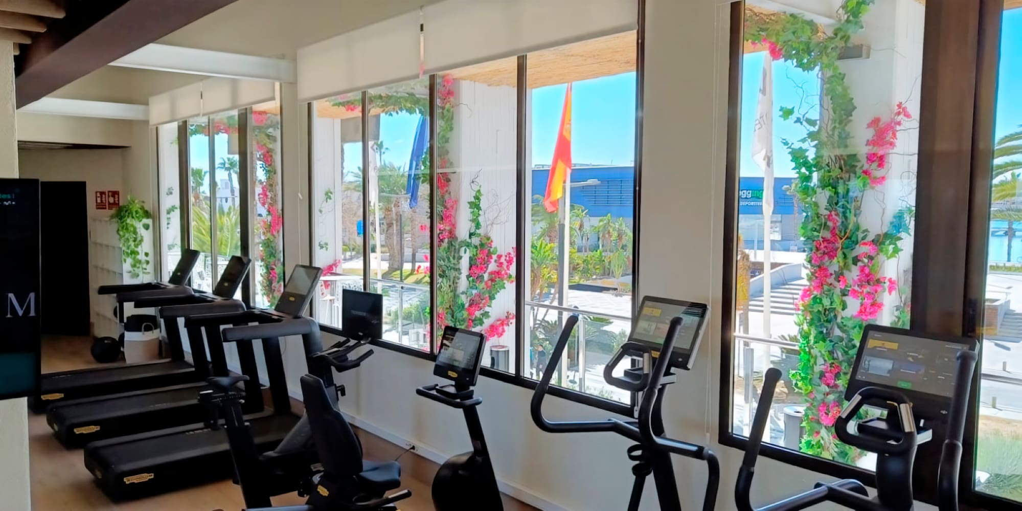 a room with exercise bikes and windows