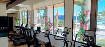 a room with exercise bikes and windows