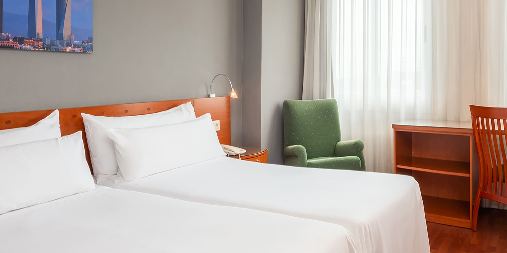 a room with two beds and a chair