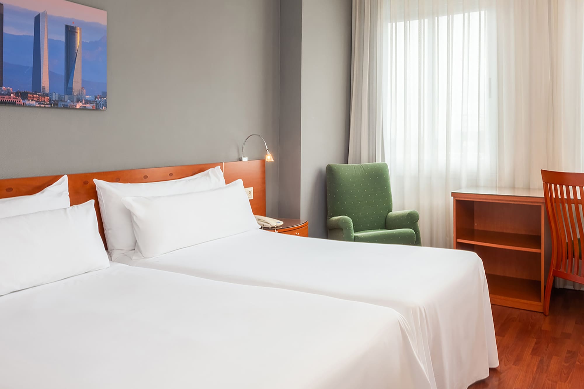 a room with two beds and a chair