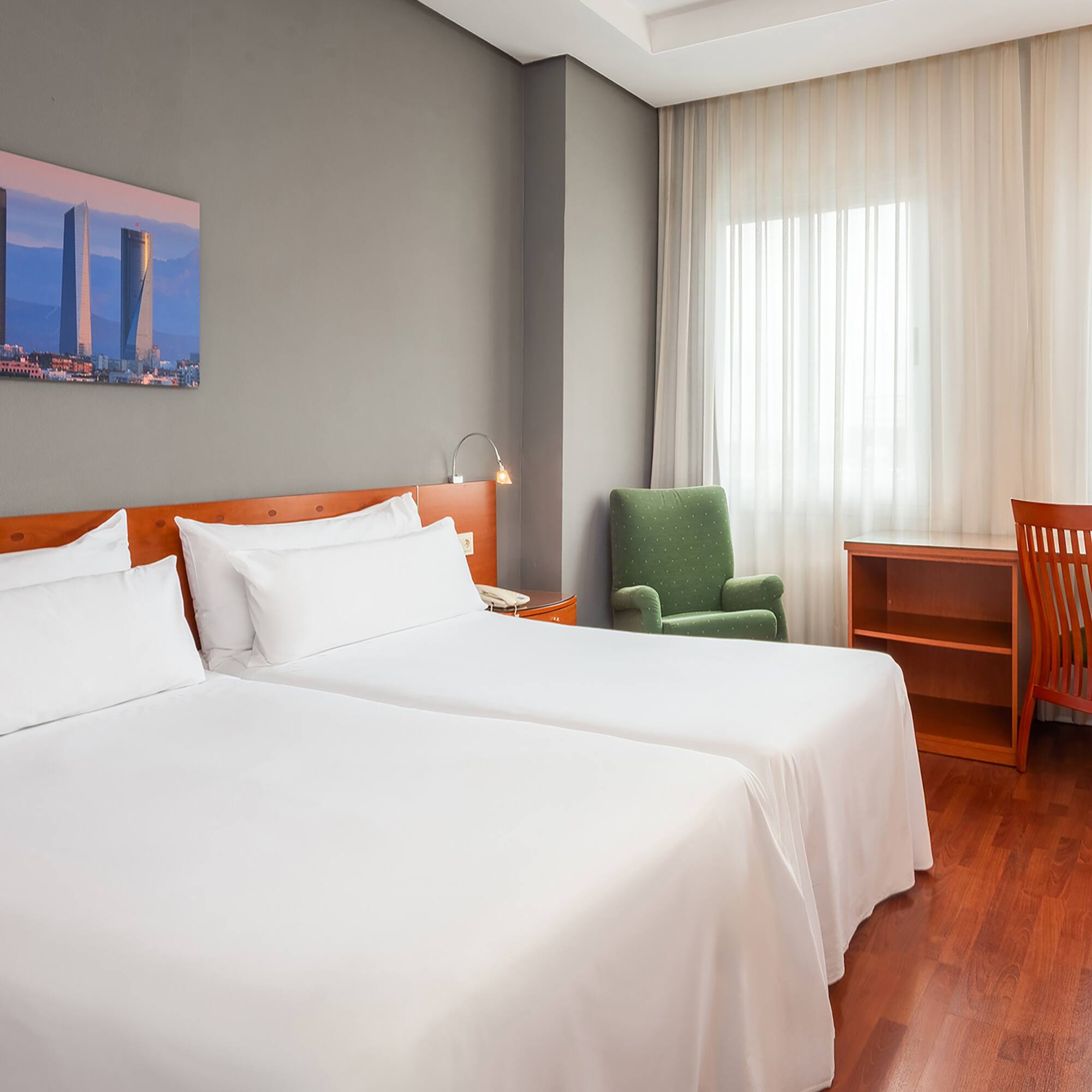 a room with two beds and a chair