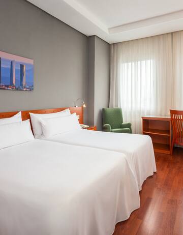 a room with two beds and a chair