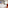 Cozy hotel room with twin beds, green armchair, desk, and cityscape art.