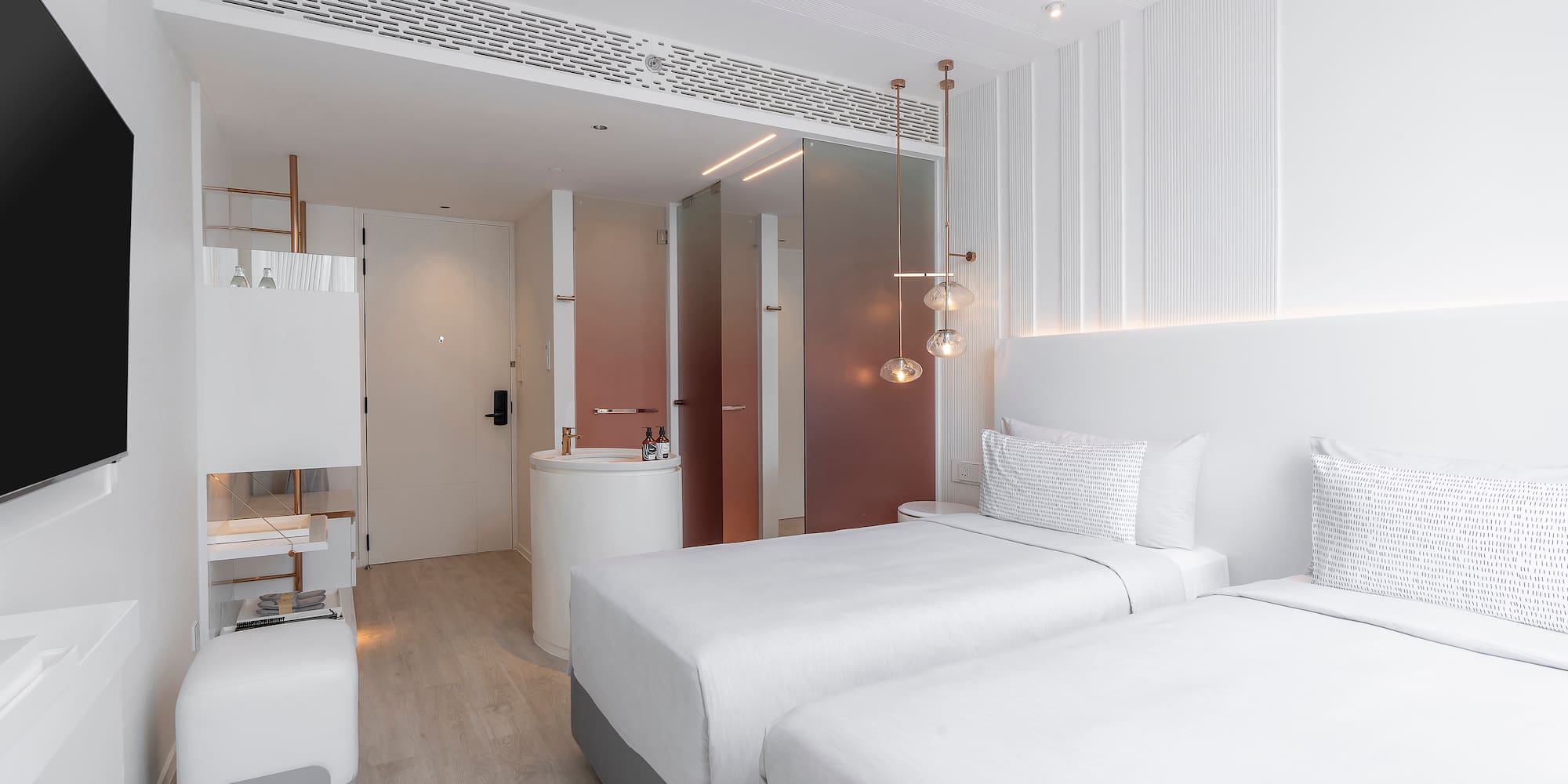 a room with two beds and a sink