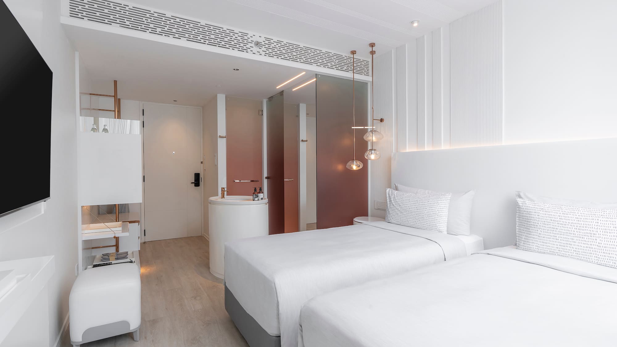 a room with two beds and a sink