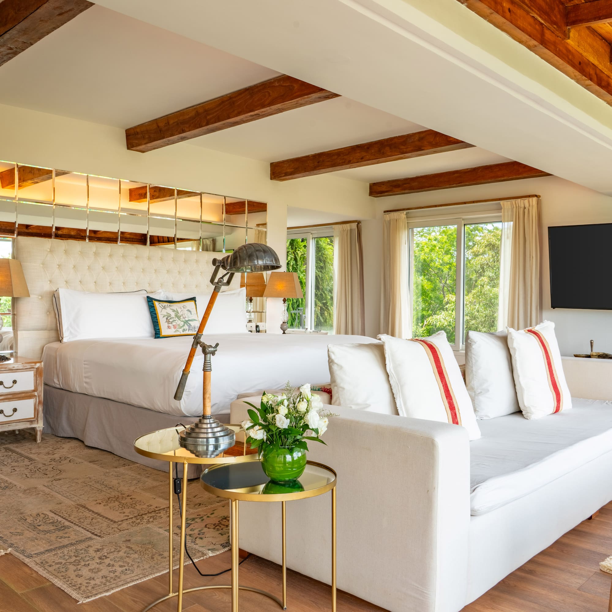 a room with a large bed and a television