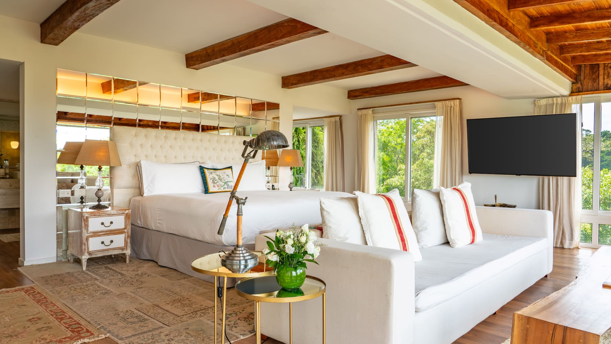 a room with a large bed and a television