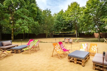 a beach chairs and volleyball net in a sandy area