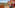 Hotel balcony overlooking Mediterranean sea, unique red resort, palm trees.