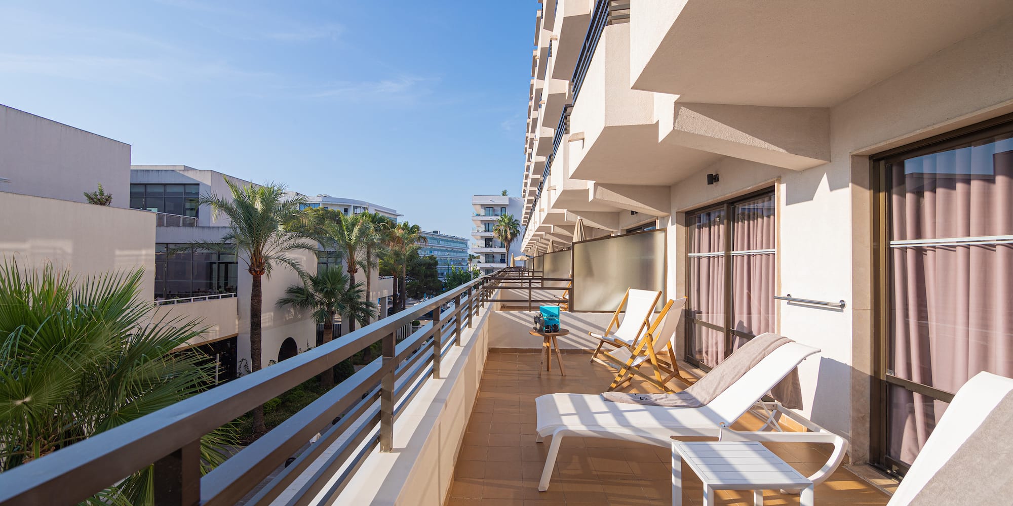 a deck with chairs and a railing on a balcony