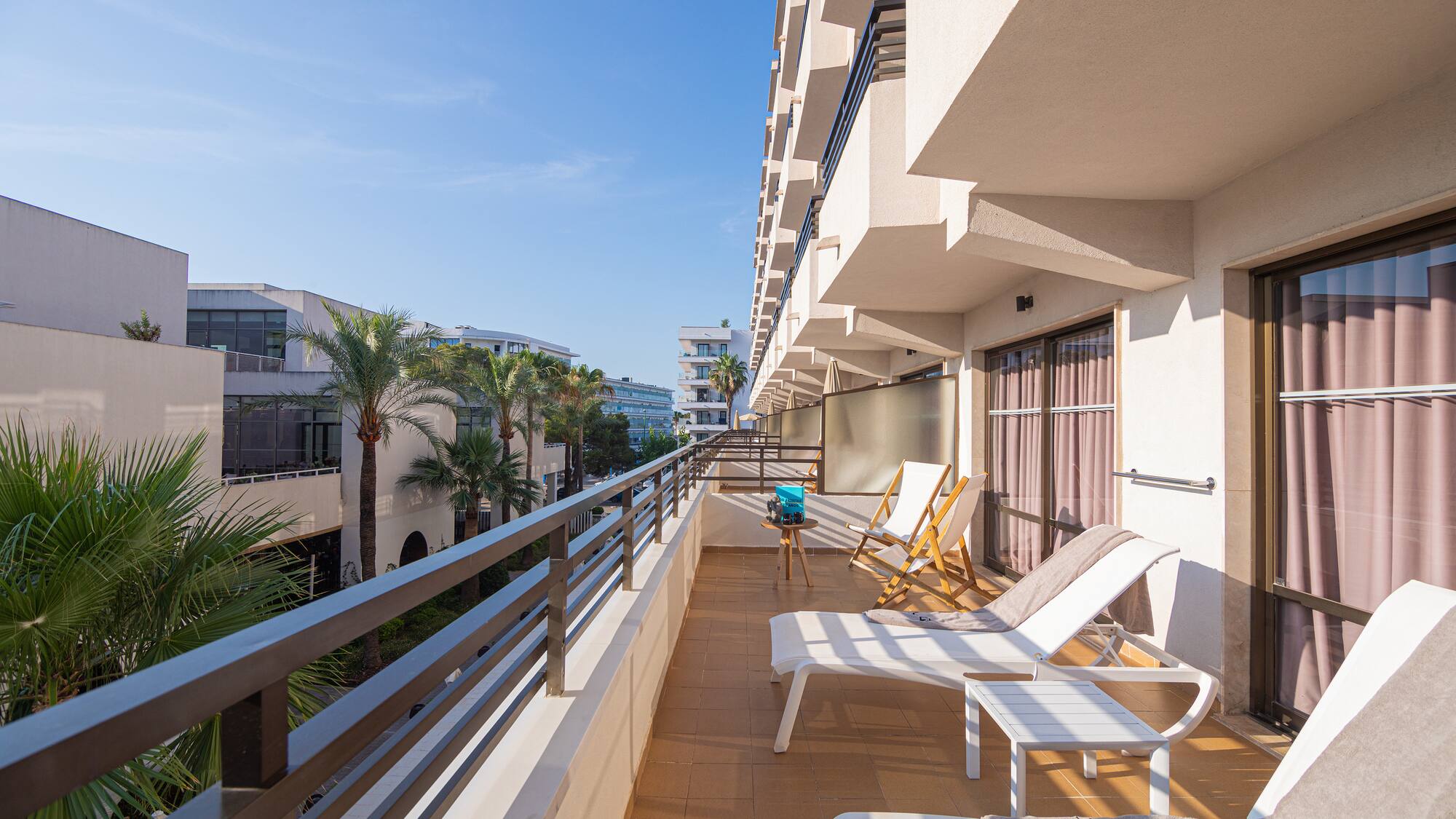a deck with chairs and a railing on a balcony