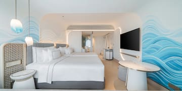 a room with two beds and a television