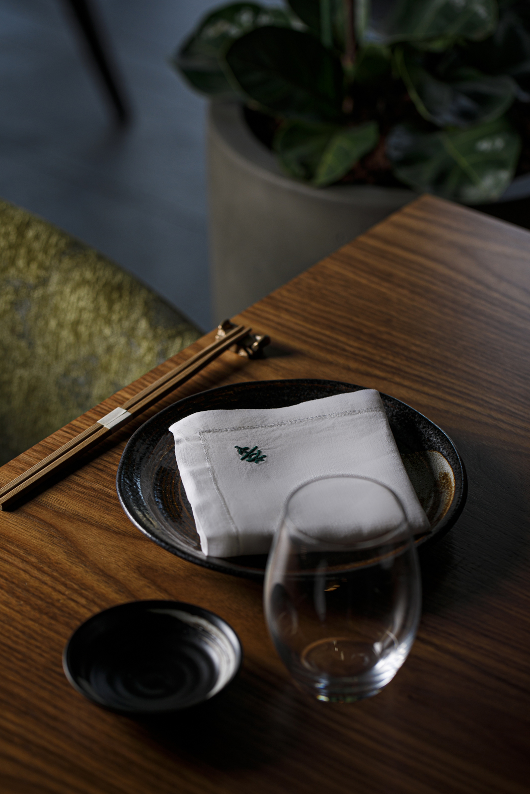 a plate with a napkin and chopsticks on a table