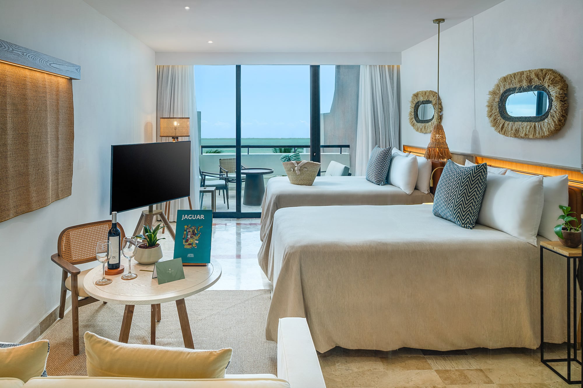 a room with two beds and a television