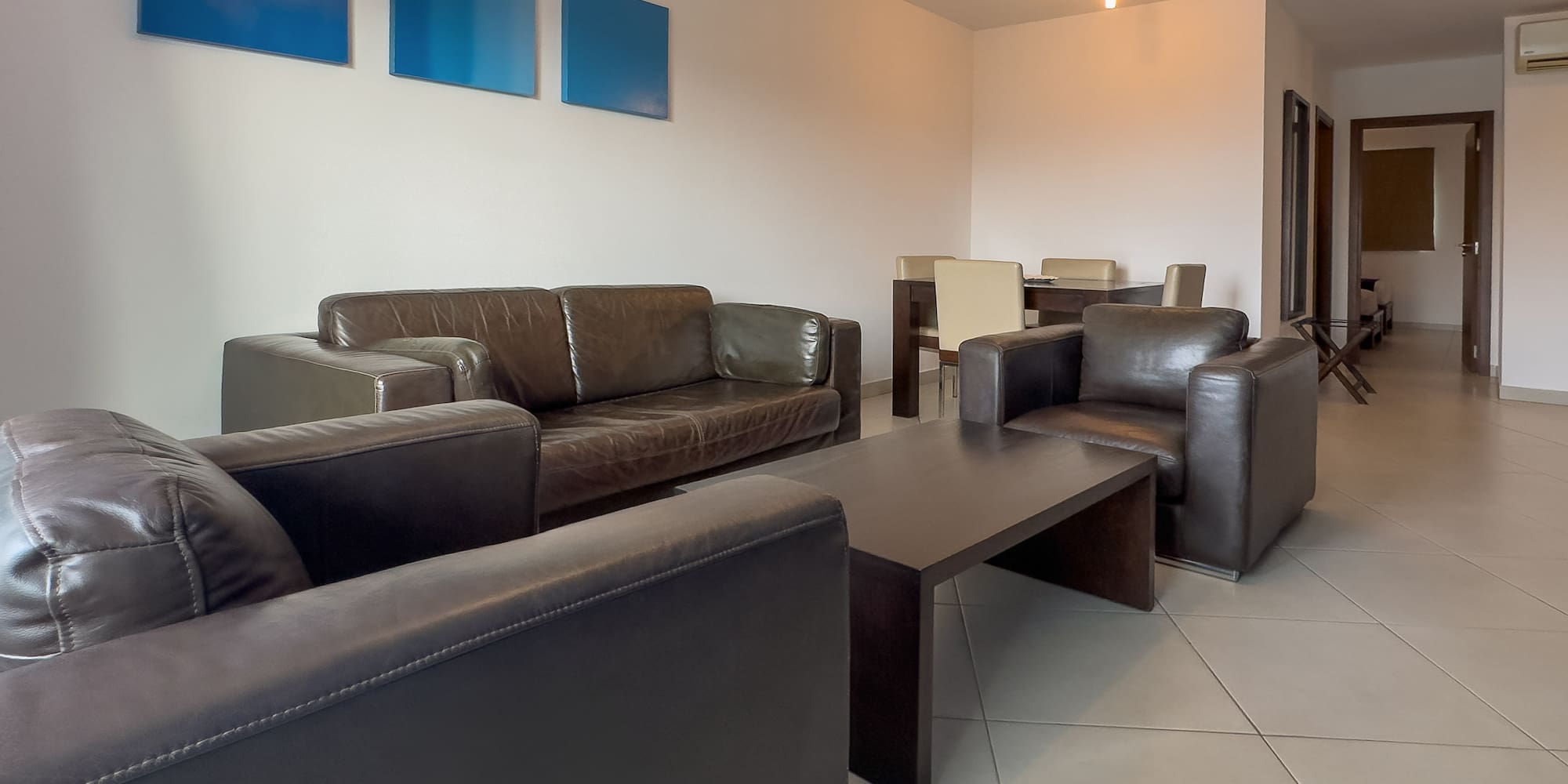 a living room with couches and chairs