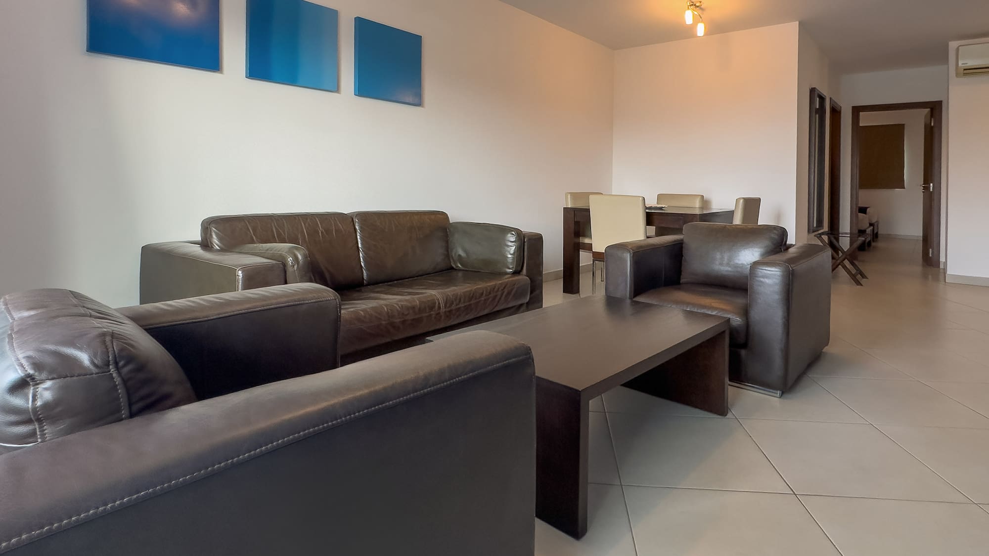 a living room with couches and chairs