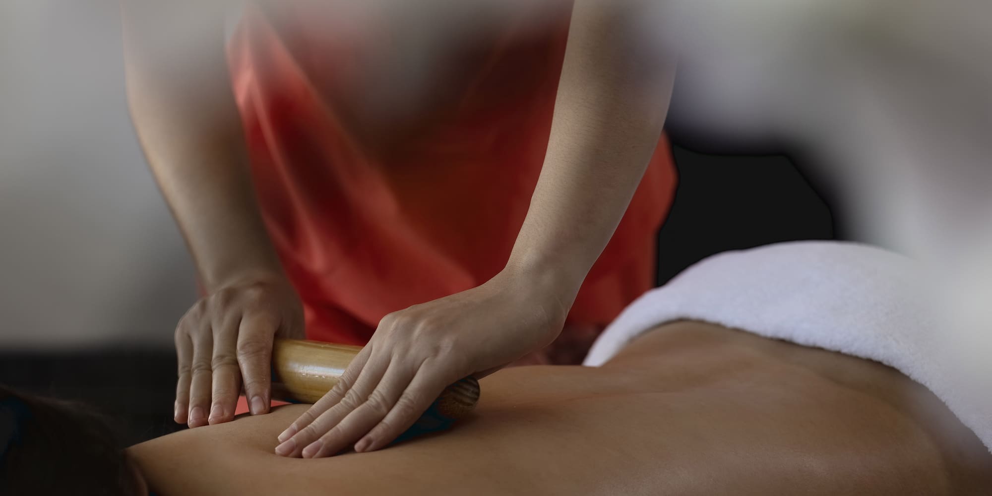 a person using a roller to massage a person's back