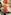 a group of glasses with orange liquid and a slice of lemon