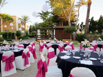 a set of tables with chairs and pink bows