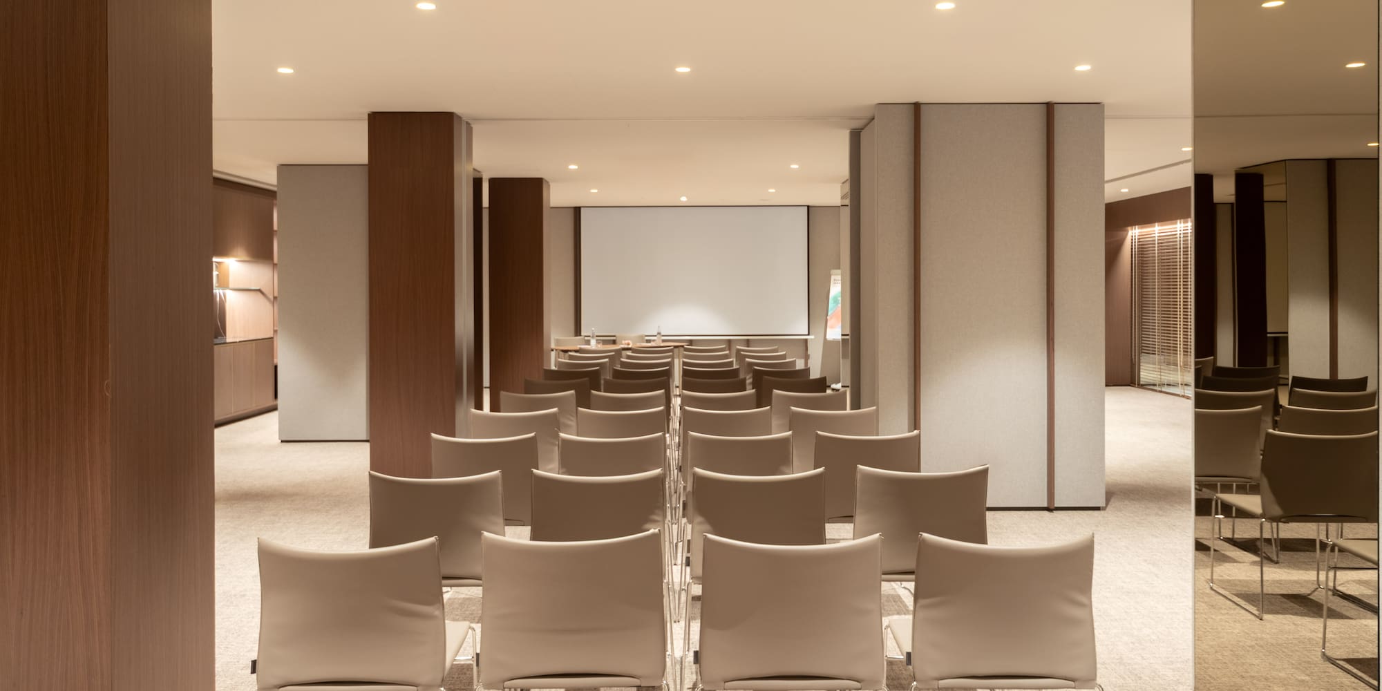 a room with chairs and a projector screen