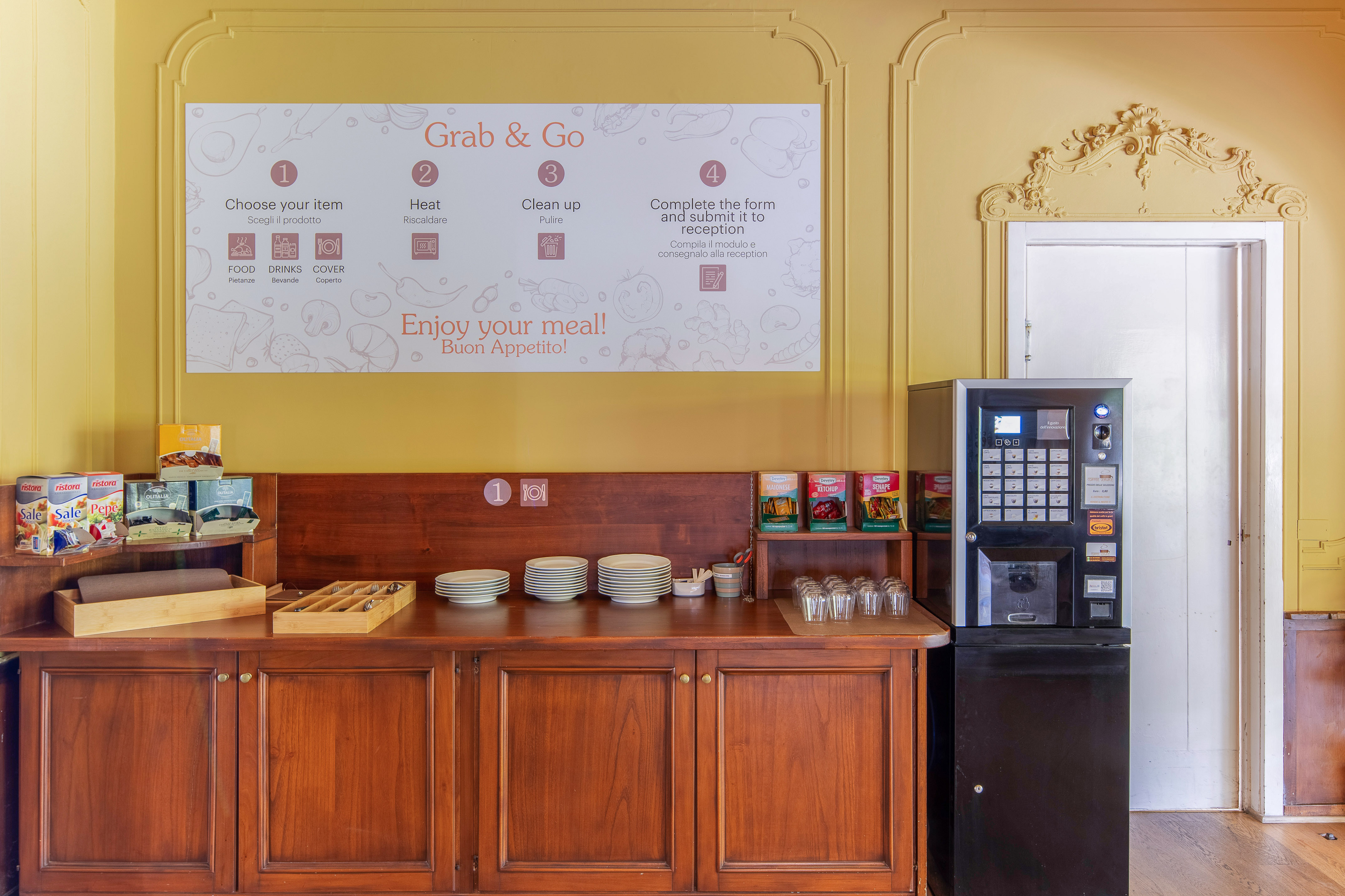 Grab & Go self-service food station with vending machine, plates, and condiments.