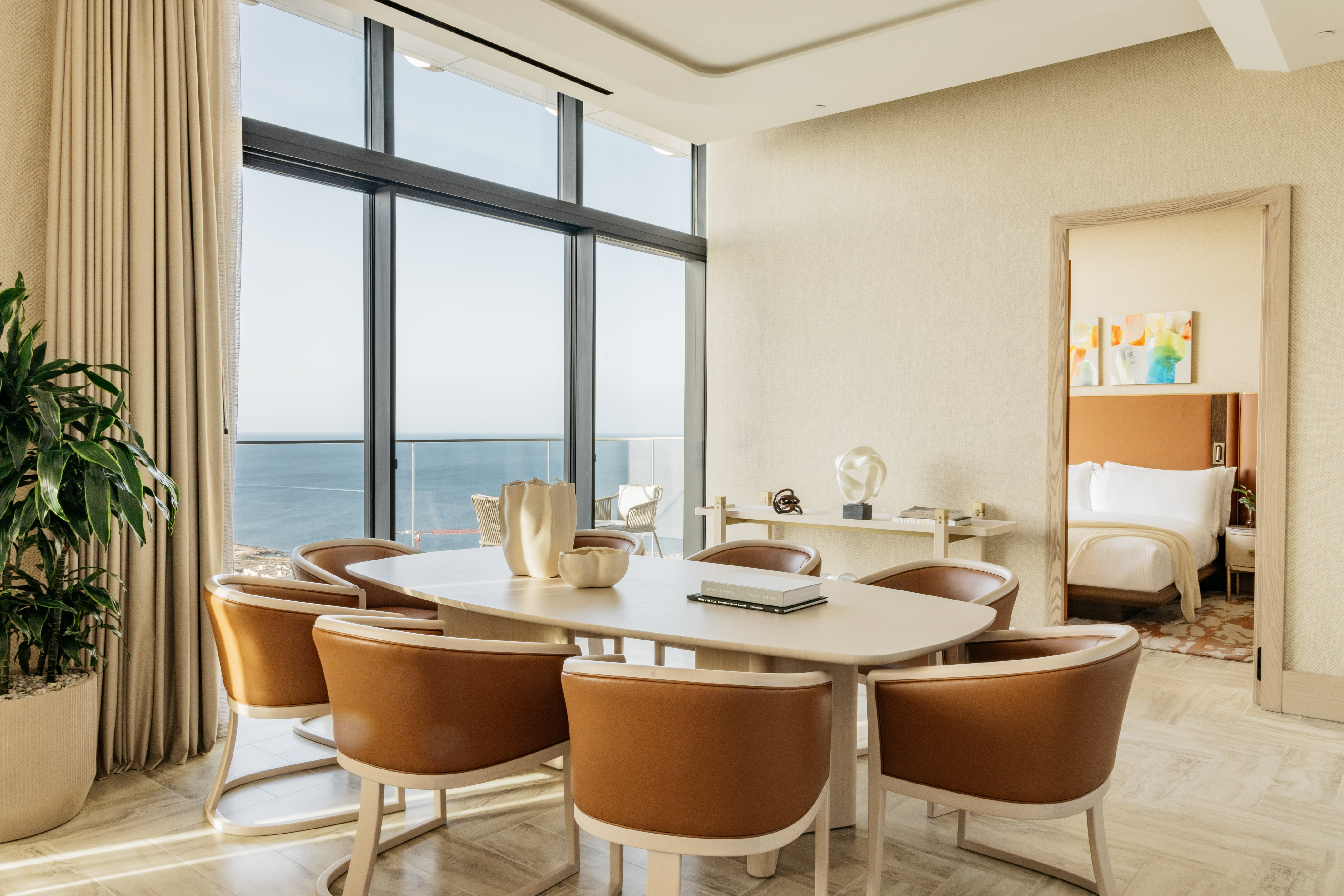 Luxury modern dining room with ocean view and brown chairs