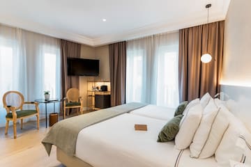 a room with a bed and a television