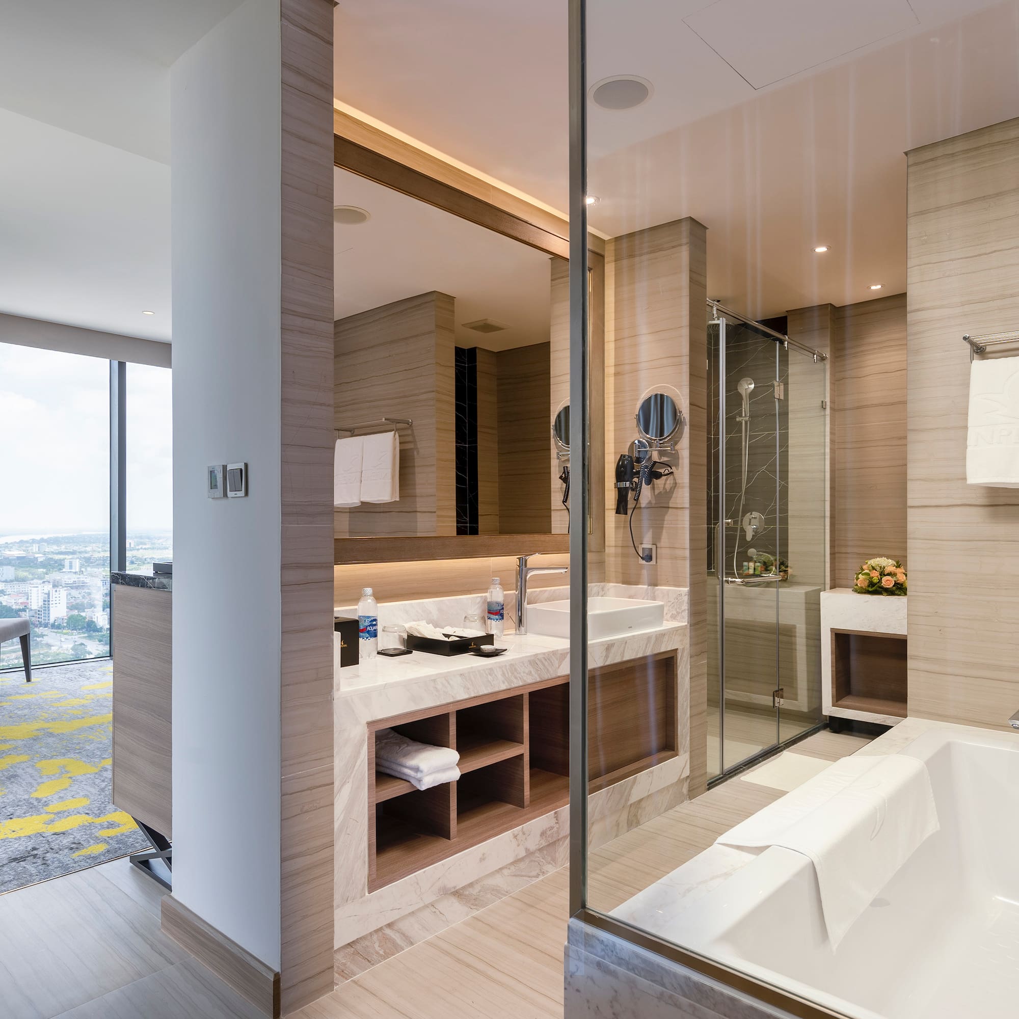 a bathroom with a glass shower and tub
