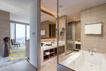 a bathroom with a glass shower and tub