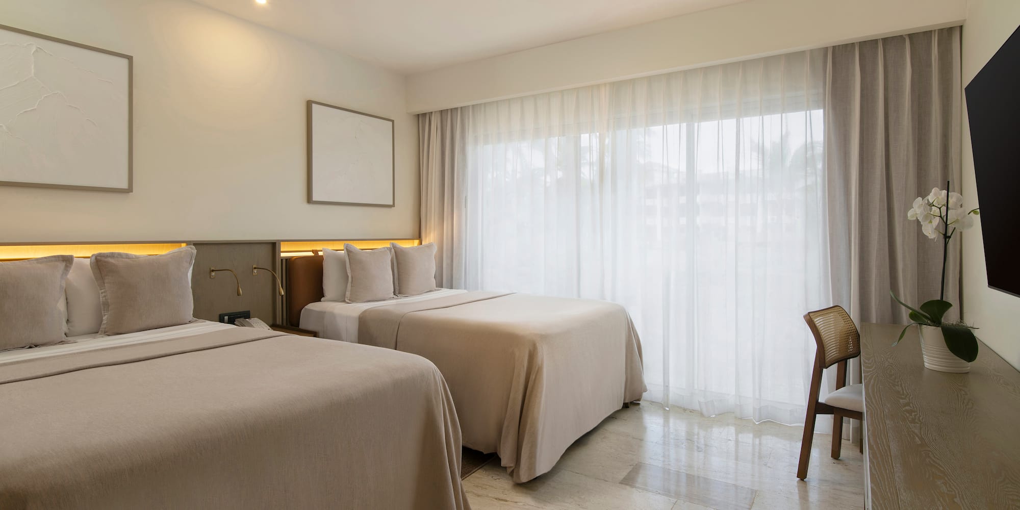 a room with two beds and a chair