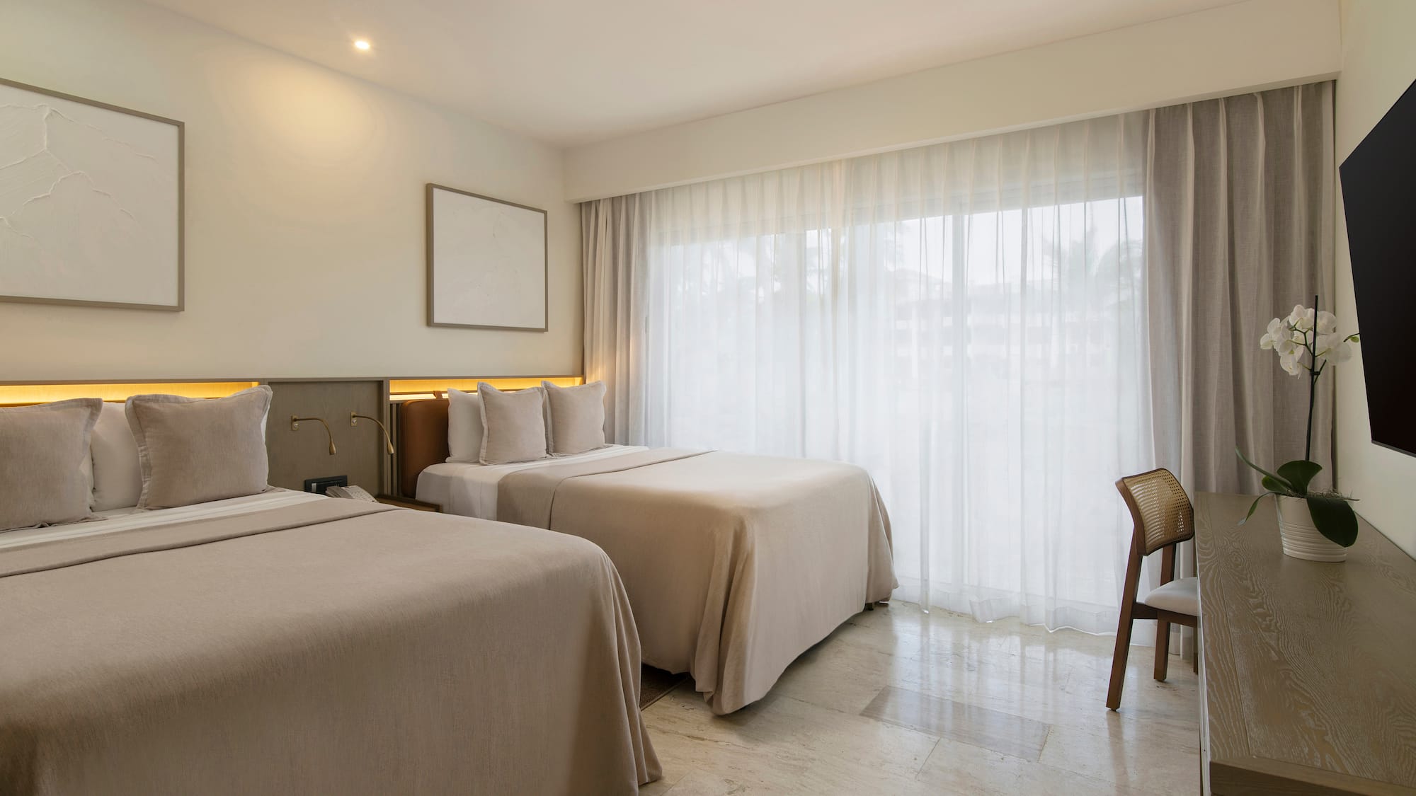 a room with two beds and a chair