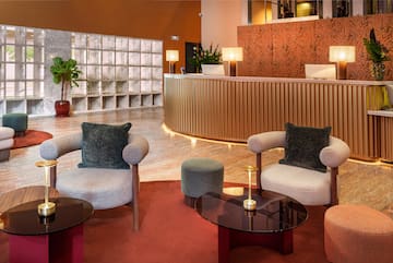 a lobby with a reception desk and chairs