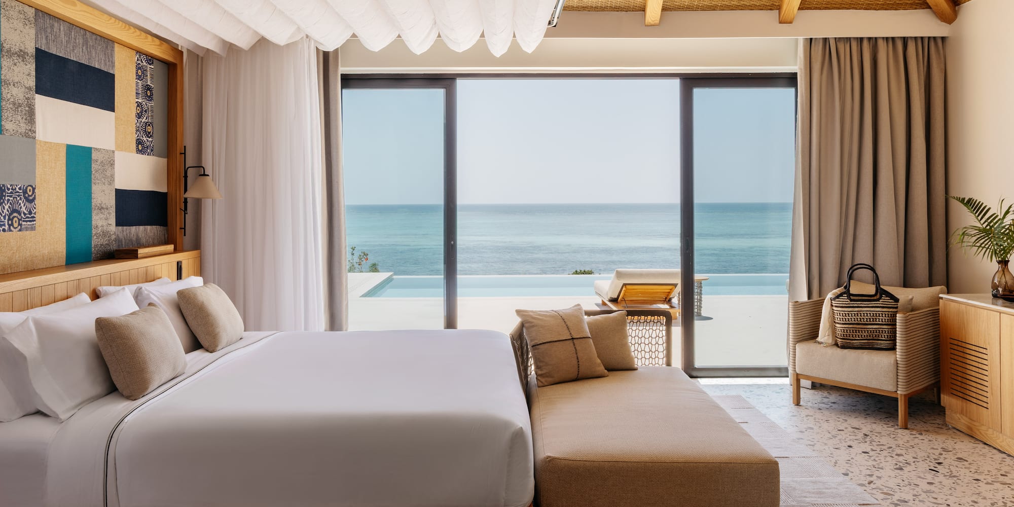 a bedroom with a large bed and a couch and a pool