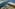 Aerial view: Large coastal resort, sandy beaches, long jetty, and channel.