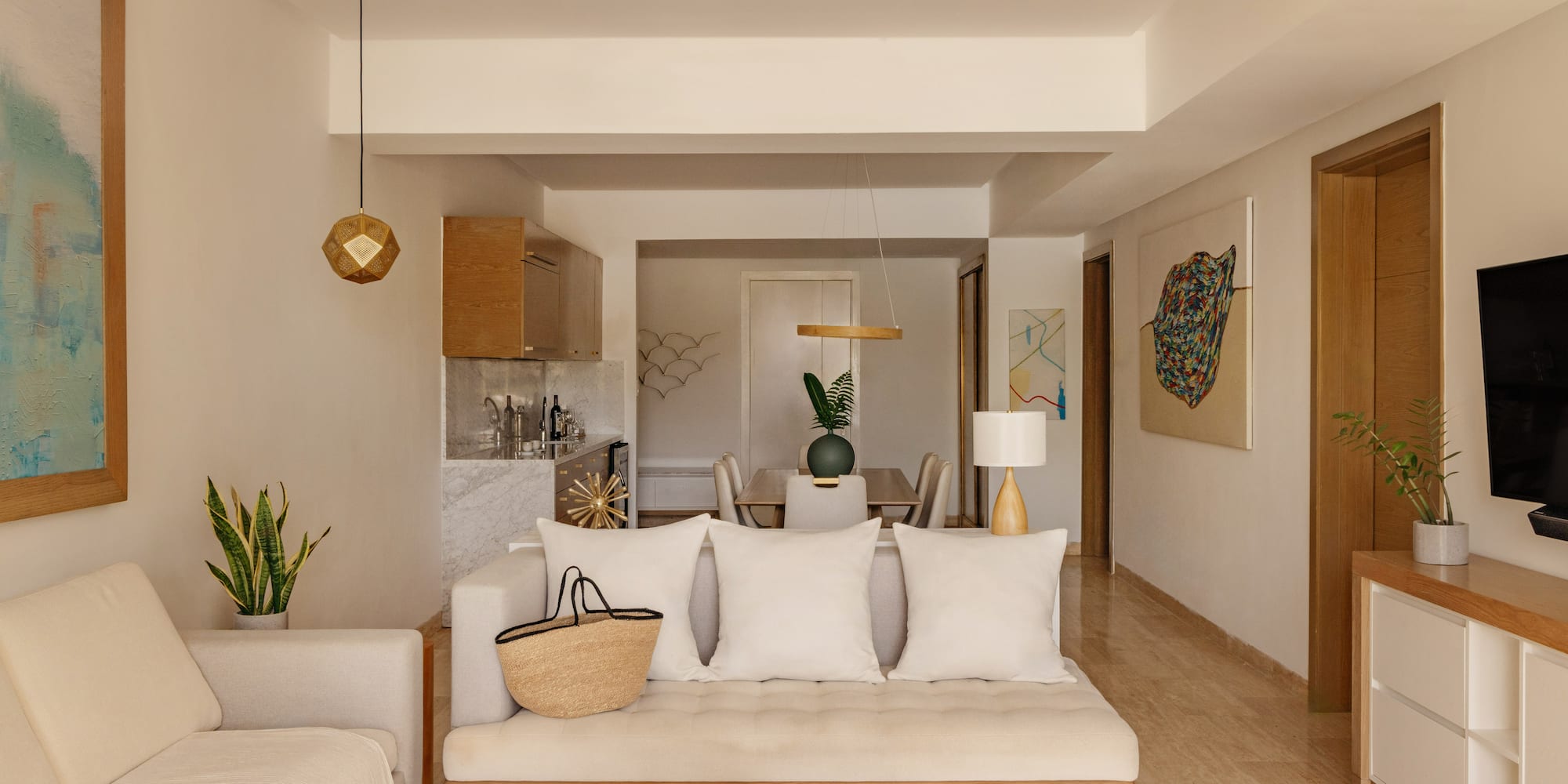 Open-concept living and dining room with neutral modern decor, cream sofa.