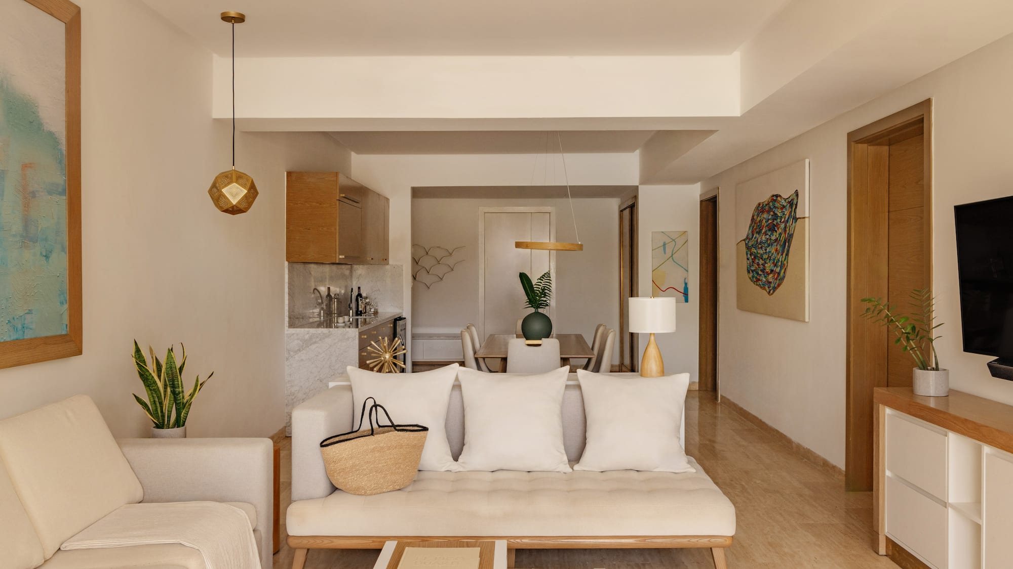 Modern neutral living room and dining area with natural wood accents.