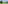 Ibirapuera Park lake, green trees, blue sky, white clouds.
