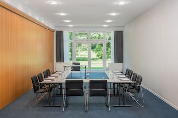 a conference room with a table and chairs