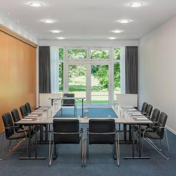 a conference room with a table and chairs