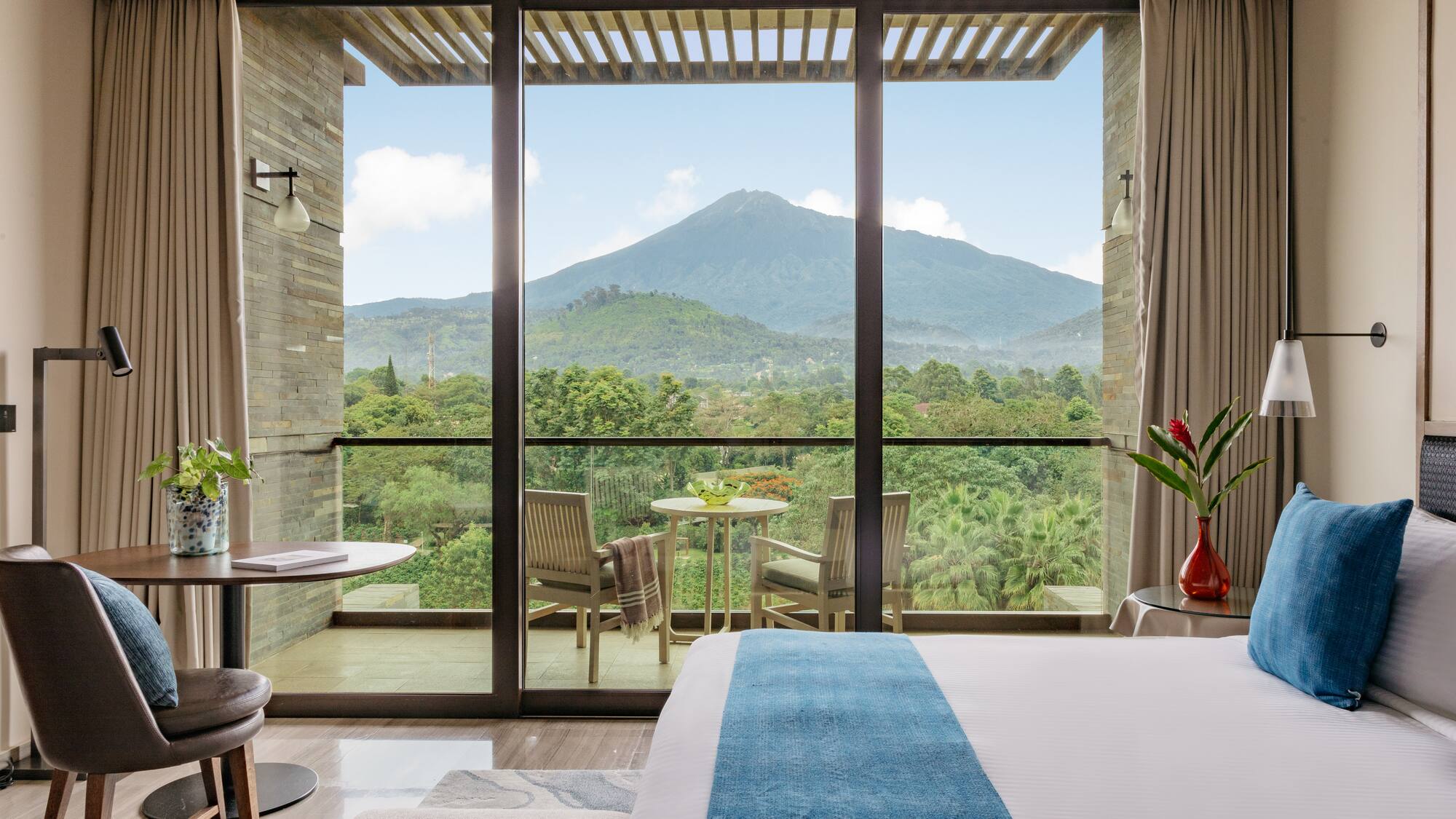a room with a view of a mountain and trees