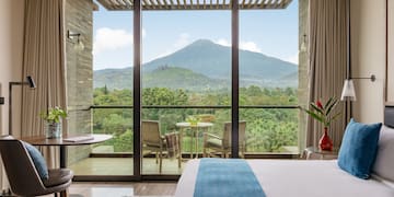 a room with a view of a mountain and trees