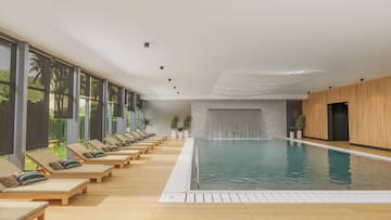 a pool with lounge chairs and a waterfall
