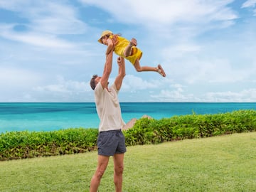 a man lifting a child up in the air