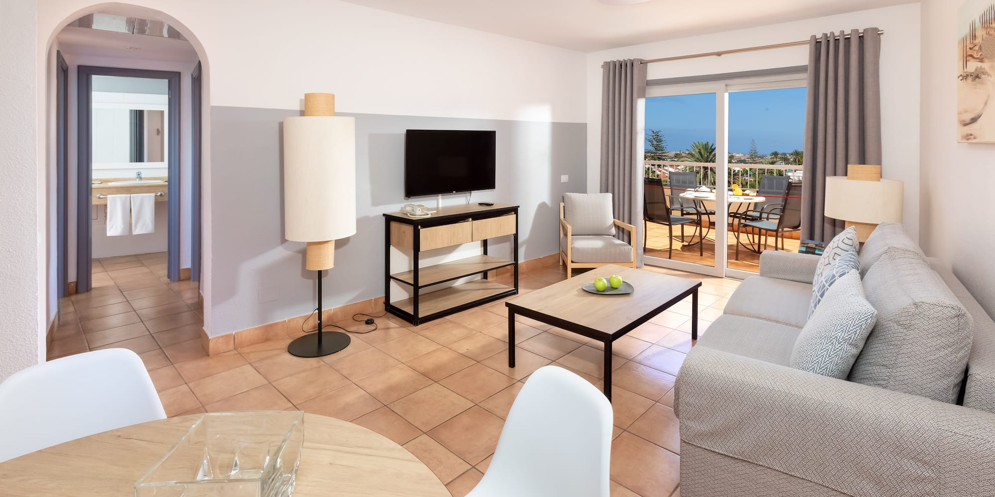 a living room with a television and a table