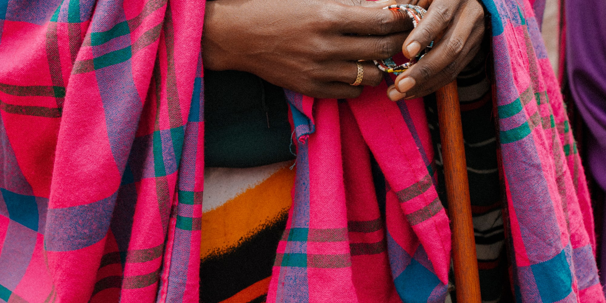 a person wearing a pink and blue plaid blanket